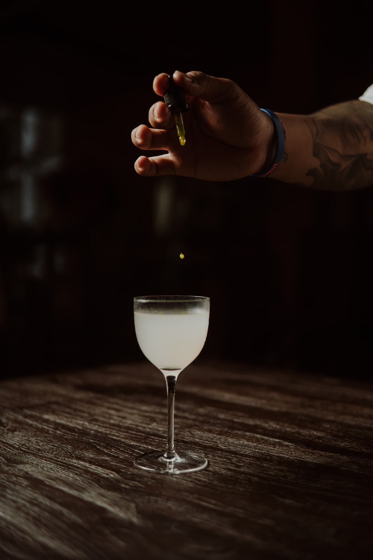 Bartender finishing a cocktail with a final drop at TAMAN