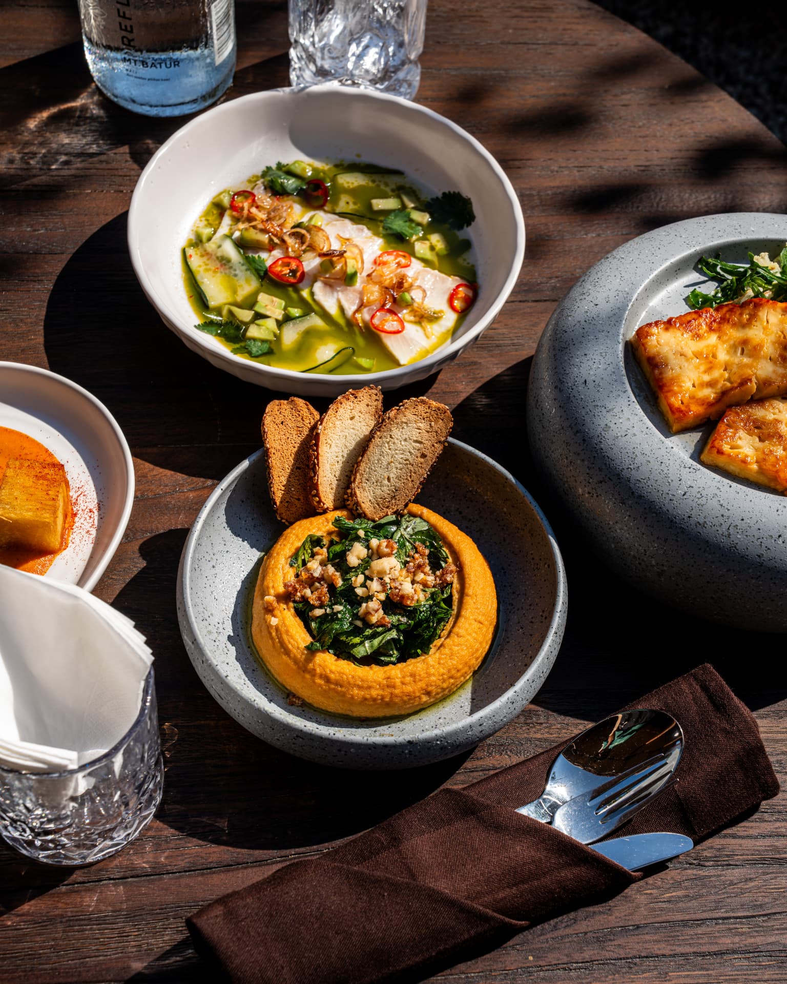A sunlit spread of contemporary sharing dishes at TAMAN