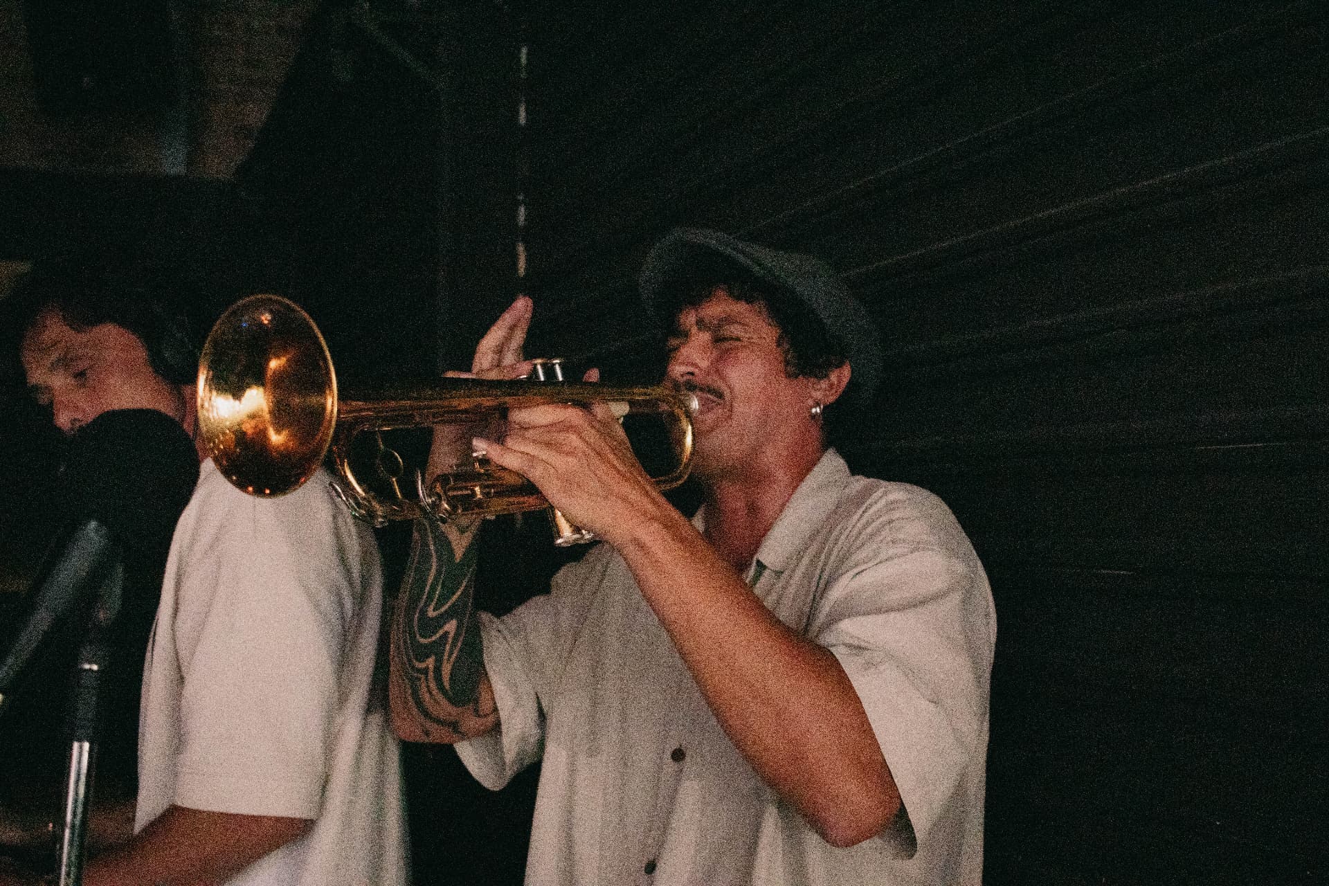 Live trumpet in warm light during a CALLORE set