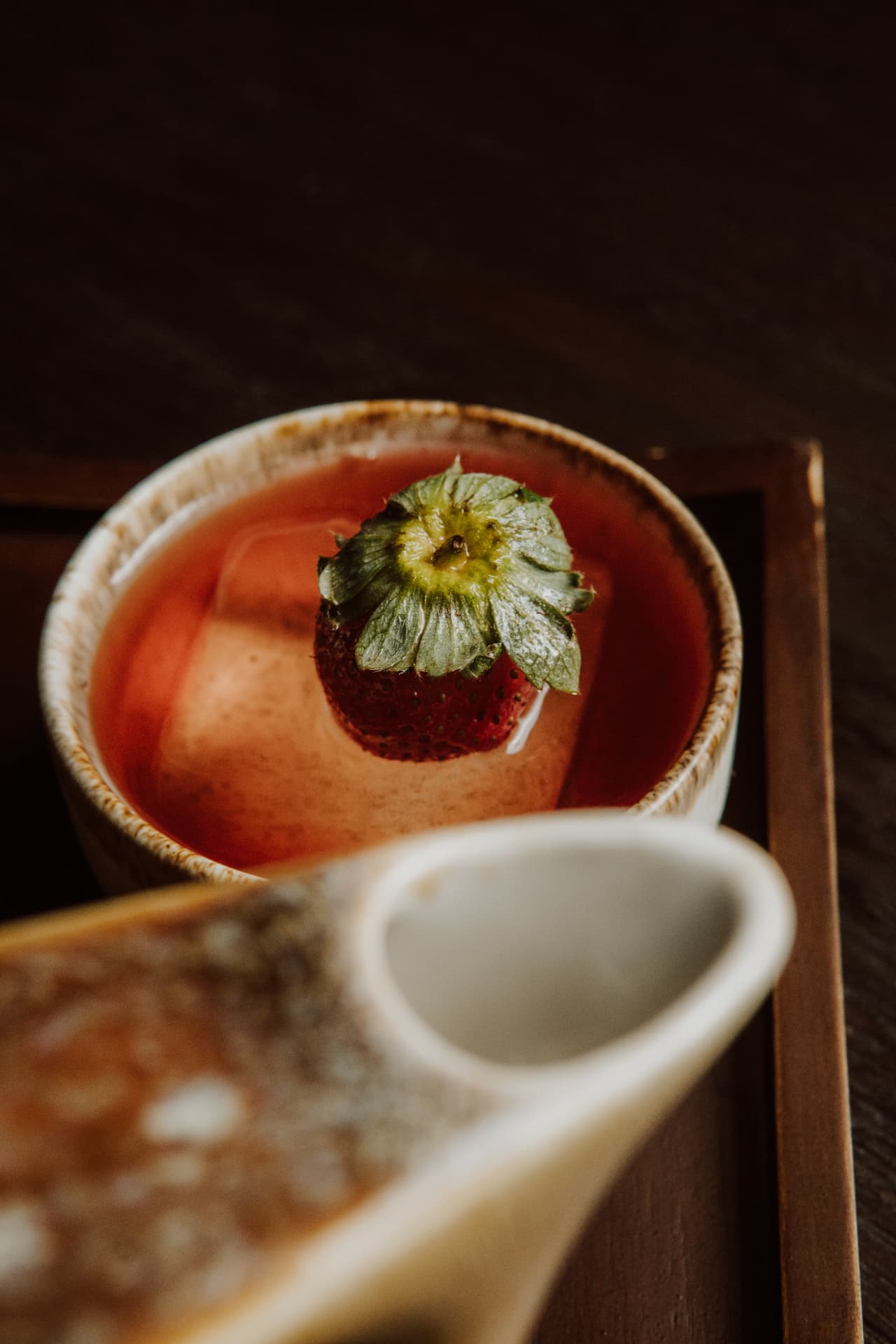 Strawberry cocktail served over a large clear ice cube at TAMAN
